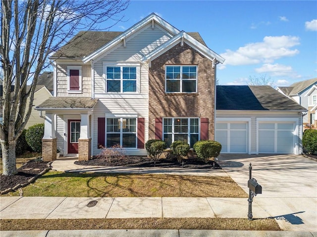 view of front of property with brick siding, driveway, and an attached garage