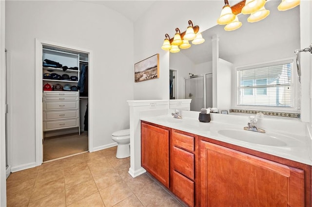 bedroom featuring vaulted ceiling, light wood-type flooring, baseboards, ceiling fan, and ensuite bathroom