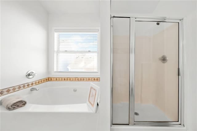 bathroom with double vanity, a sink, a stall shower, and vaulted ceiling