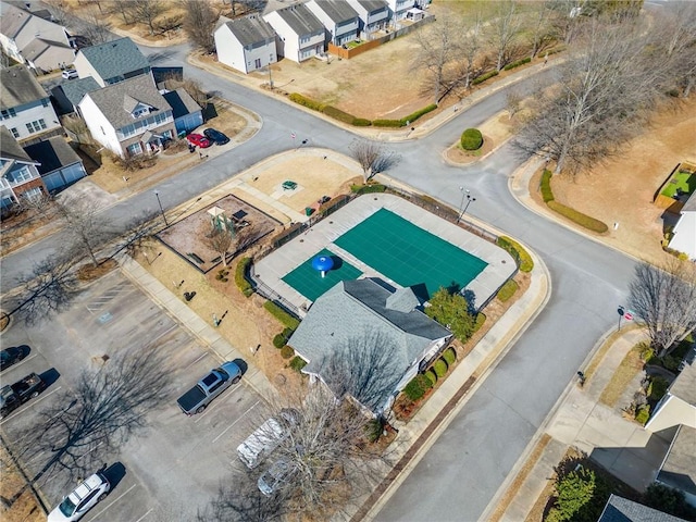 traditional-style house with a residential view, brick siding, driveway, and an attached garage