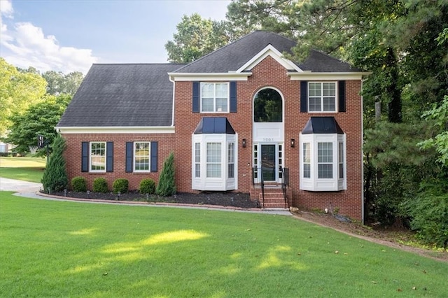1001 Braelin Ct, Woodstock, GA 30189 - colonial inspired home with entry steps, a front yard, brick siding, and roof with shingles