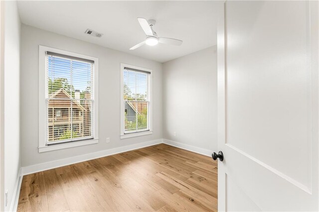 empty room with light hardwood / wood-style flooring and ceiling fan