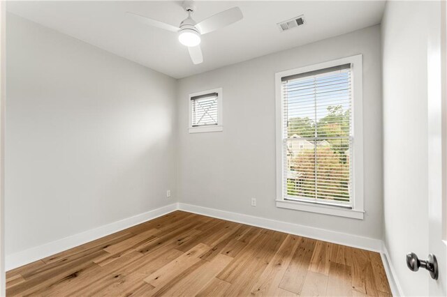 spare room with light hardwood / wood-style floors, plenty of natural light, and ceiling fan