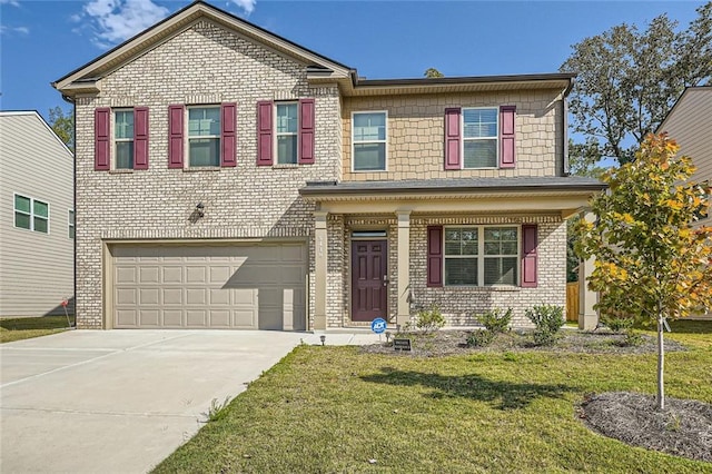 view of front of home featuring a garage and a front yard