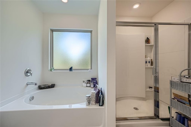 bathroom featuring separate shower and tub