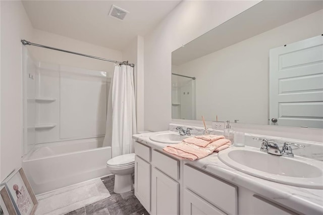 full bathroom featuring shower / bath combination with curtain, toilet, and vanity