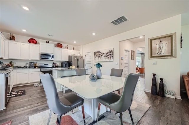 dining area featuring dark hardwood / wood-style floors and beverage cooler