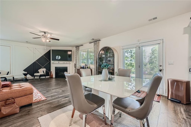 dining area with dark hardwood / wood-style floors, a healthy amount of sunlight, and ceiling fan