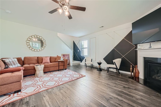 living room featuring hardwood / wood-style floors and ceiling fan