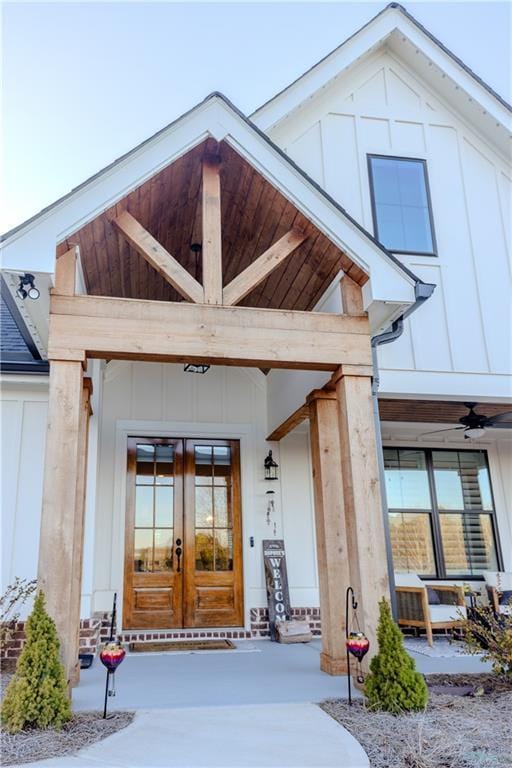 entrance to property with a porch and french doors