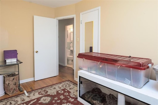 bedroom featuring baseboards and wood finished floors