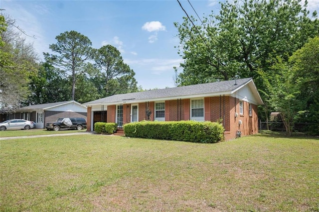ranch-style house featuring driveway, a front yard, brick siding, and a garage