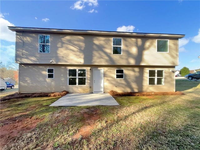 back of property featuring a patio and a yard