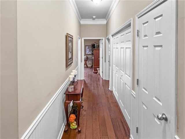 corridor featuring dark wood finished floors and crown molding