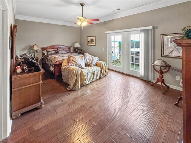 bedroom with wood finished floors, visible vents, baseboards, crown molding, and access to outside