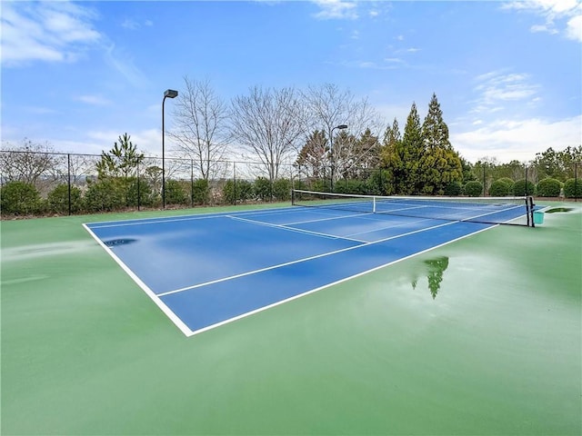 view of tennis court with fence