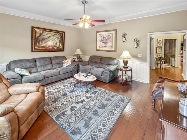 living area featuring crown molding, hardwood / wood-style flooring, a ceiling fan, and wainscoting