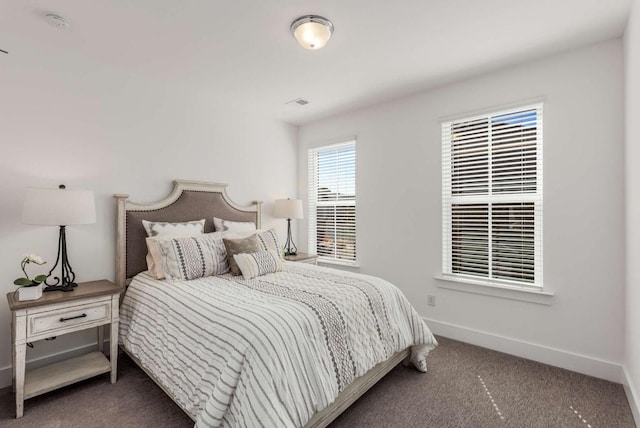 carpeted bedroom featuring baseboards