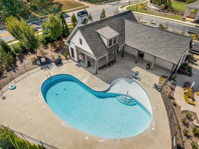 community pool featuring a patio area and fence