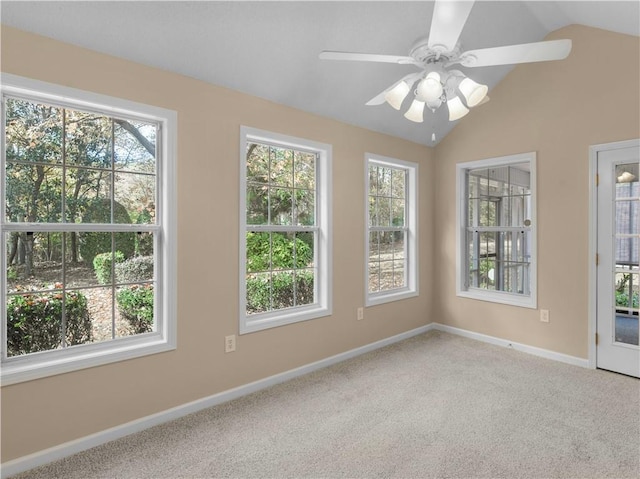 spare room with vaulted ceiling, carpet floors, and plenty of natural light