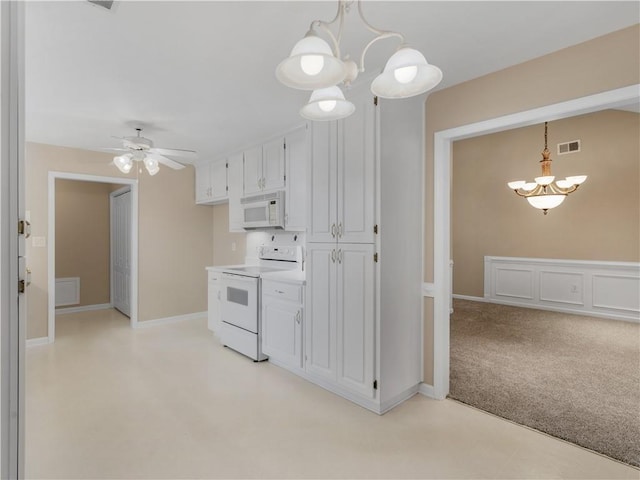 kitchen with light countertops, visible vents, light carpet, white cabinets, and white appliances