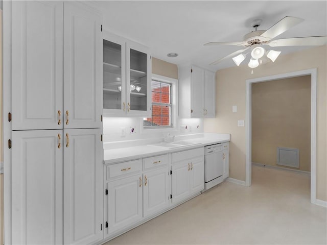 kitchen featuring white cabinets, white dishwasher, glass insert cabinets, and light countertops