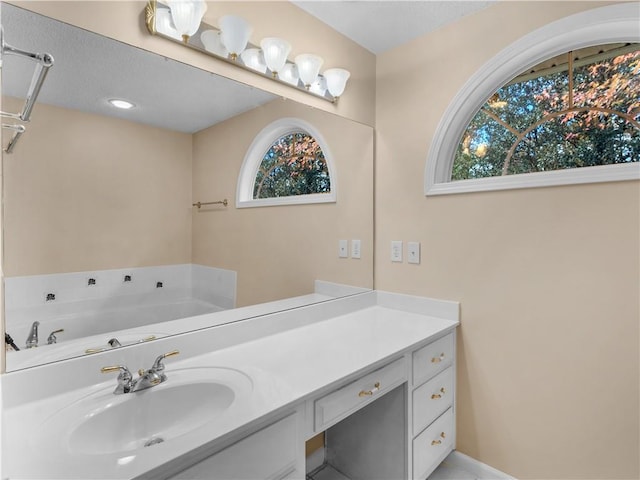 bathroom with a bath and vanity