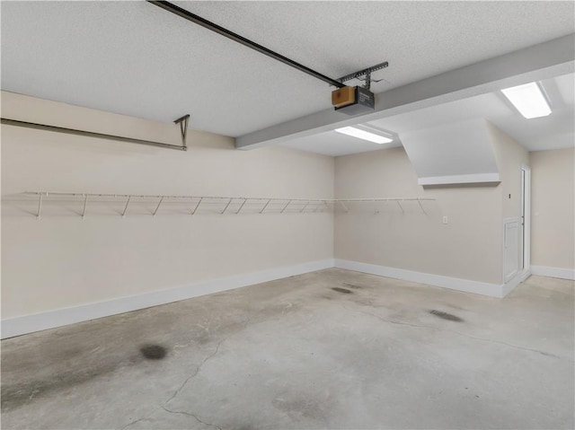 garage featuring a garage door opener and baseboards