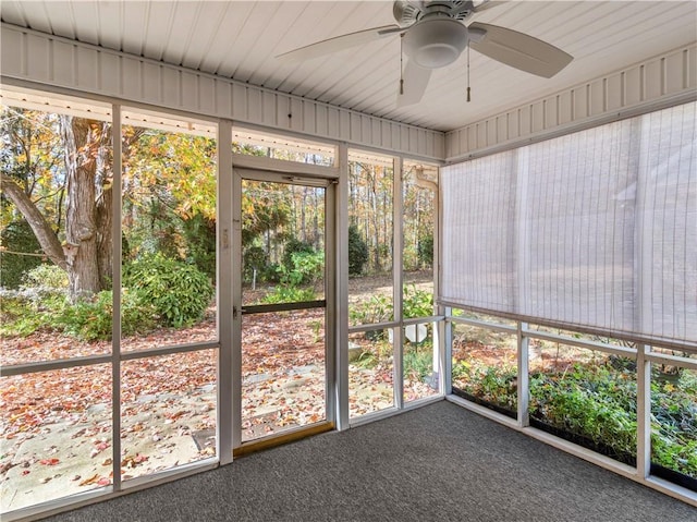 unfurnished sunroom with a ceiling fan and plenty of natural light