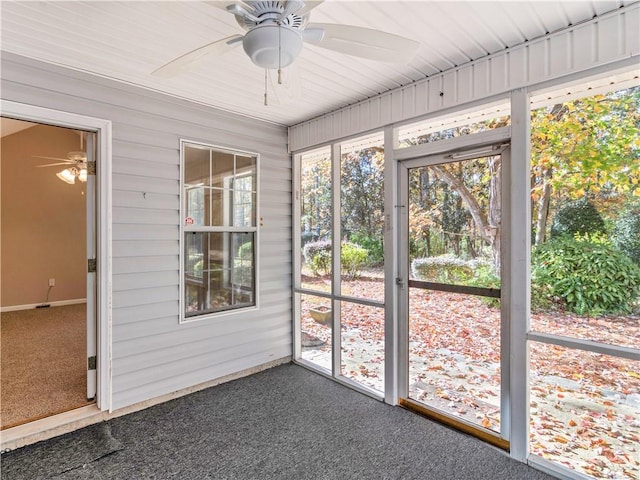 unfurnished sunroom featuring a ceiling fan