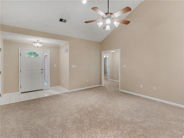 entrance foyer featuring light tile patterned floors, baseboards, and light colored carpet