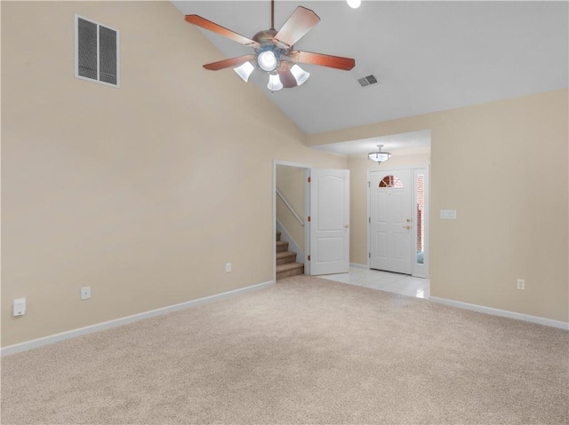 spare room with light carpet, ceiling fan, stairs, and visible vents