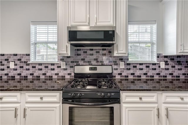 kitchen with white cabinets, backsplash, and stainless steel appliances