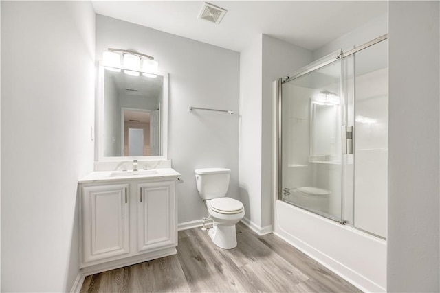 bathroom featuring vanity, wood finished floors, visible vents, baseboards, and toilet