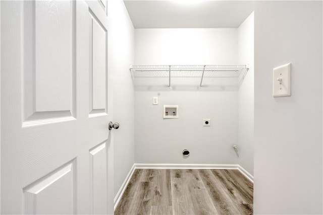 washroom with wood finished floors, baseboards, hookup for an electric dryer, laundry area, and washer hookup