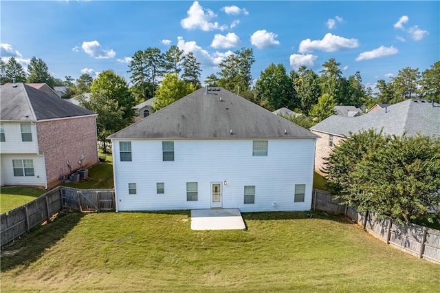 back of property featuring a yard, a fenced backyard, and a patio area