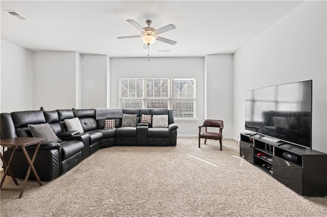 carpeted living room featuring ceiling fan and a healthy amount of sunlight