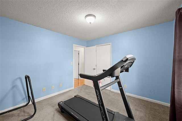 workout room with carpet floors and a textured ceiling