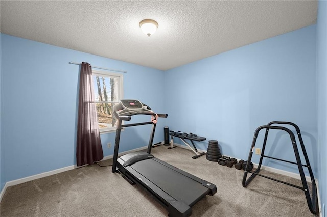 workout room with a textured ceiling and carpet floors