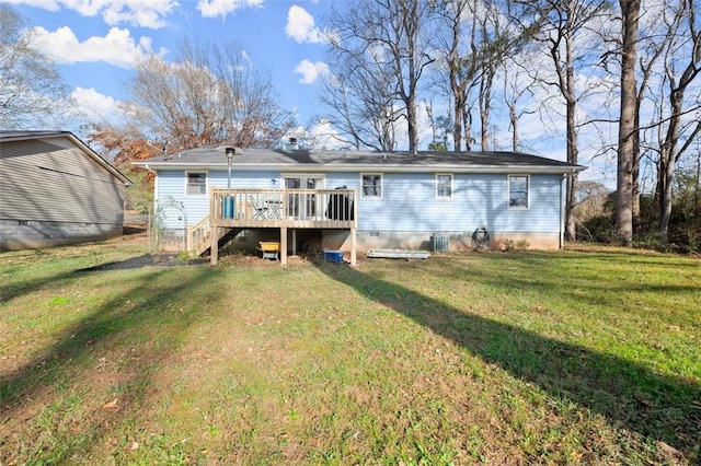 rear view of house featuring a yard and a deck