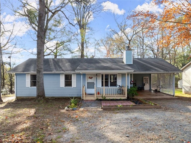 ranch-style home with a porch and a carport