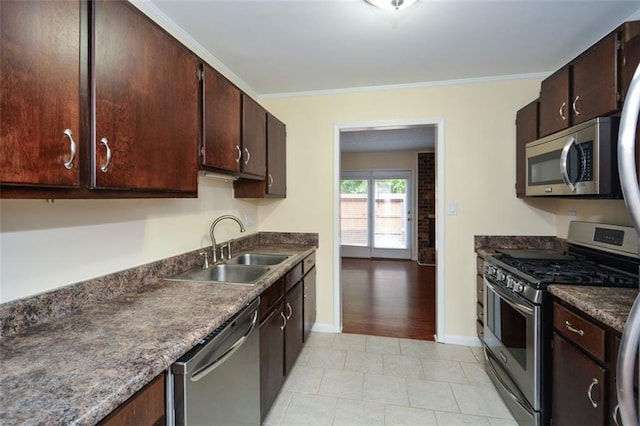 kitchen with dark brown cabinetry, sink, crown molding, and appliances with stainless steel finishes