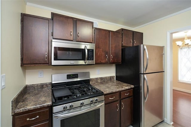 kitchen with crown molding, appliances with stainless steel finishes, dark brown cabinets, and a notable chandelier