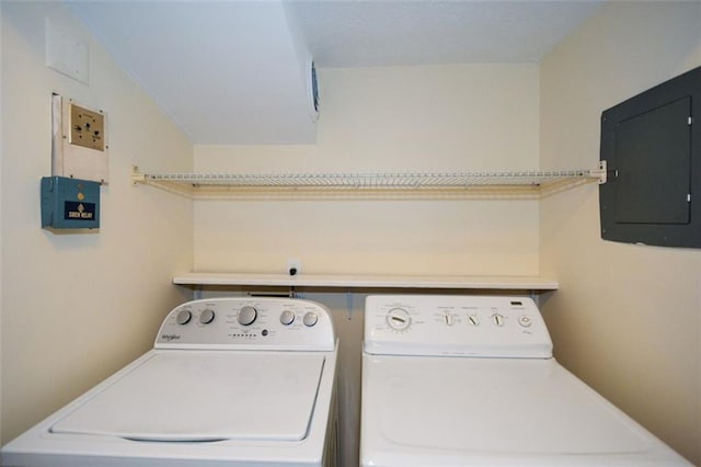 laundry room with washing machine and clothes dryer and electric panel