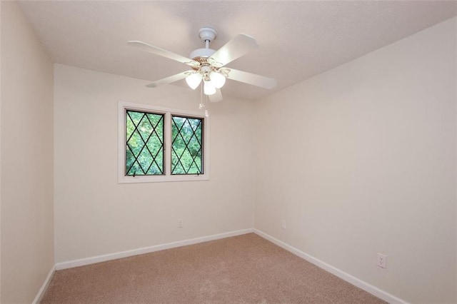 empty room featuring ceiling fan and carpet flooring