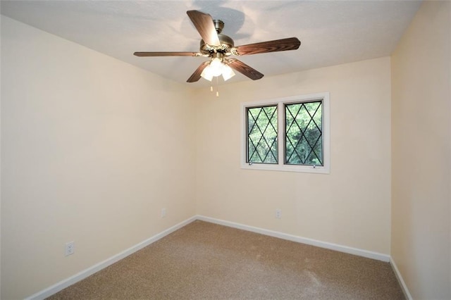 spare room featuring carpet and ceiling fan