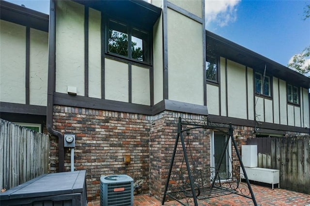 view of home's exterior featuring central AC unit and a patio