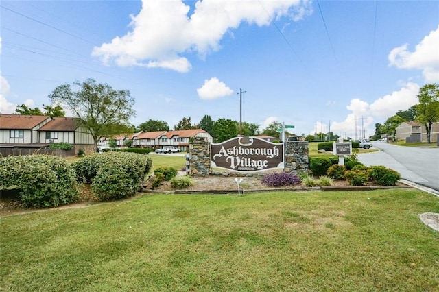 community / neighborhood sign with a lawn