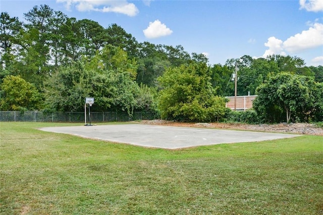 view of sport court with a yard