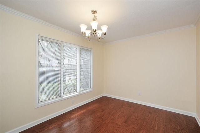 spare room with crown molding, plenty of natural light, dark hardwood / wood-style floors, and a chandelier